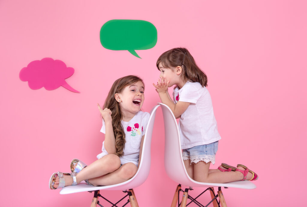 WorldBrain+ two little girls colored wall with speech icons